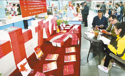 十一月五日，讀者在新疆烏魯木齊市新華國際圖書城黨的十九大讀物展臺(tái)前翻閱選購十九大學(xué)習(xí)輔導(dǎo)讀物。