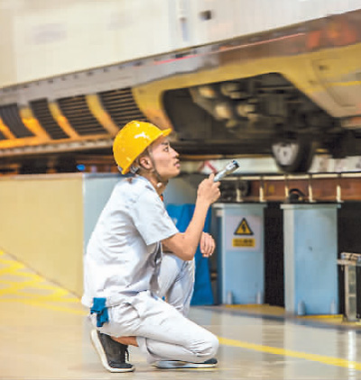 7月18日，西安鐵路局西安動車段，動車組檢修師一絲不茍地查看入庫動車組車輪狀態(tài)。 